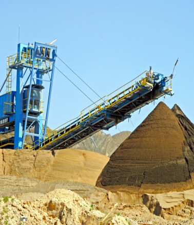 Bulk material conveyor and stockpiles in an industrial setting, monitored for safety by AP Sensing Bulk material conveyor and stockpiles in an industrial setting, monitored for safety by AP Sensing
