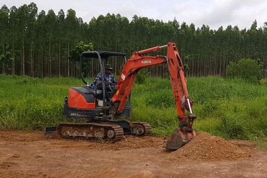 Mini excavator digs, site preparation for assets needing distributed fiber optic monitoring solutions Mini excavator digs, site preparation for assets needing distributed fiber optic monitoring solutions